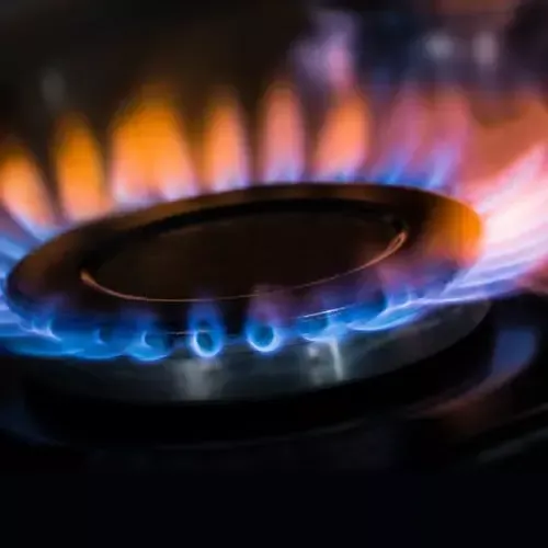 A close up of a gas burner with flames coming out of it.