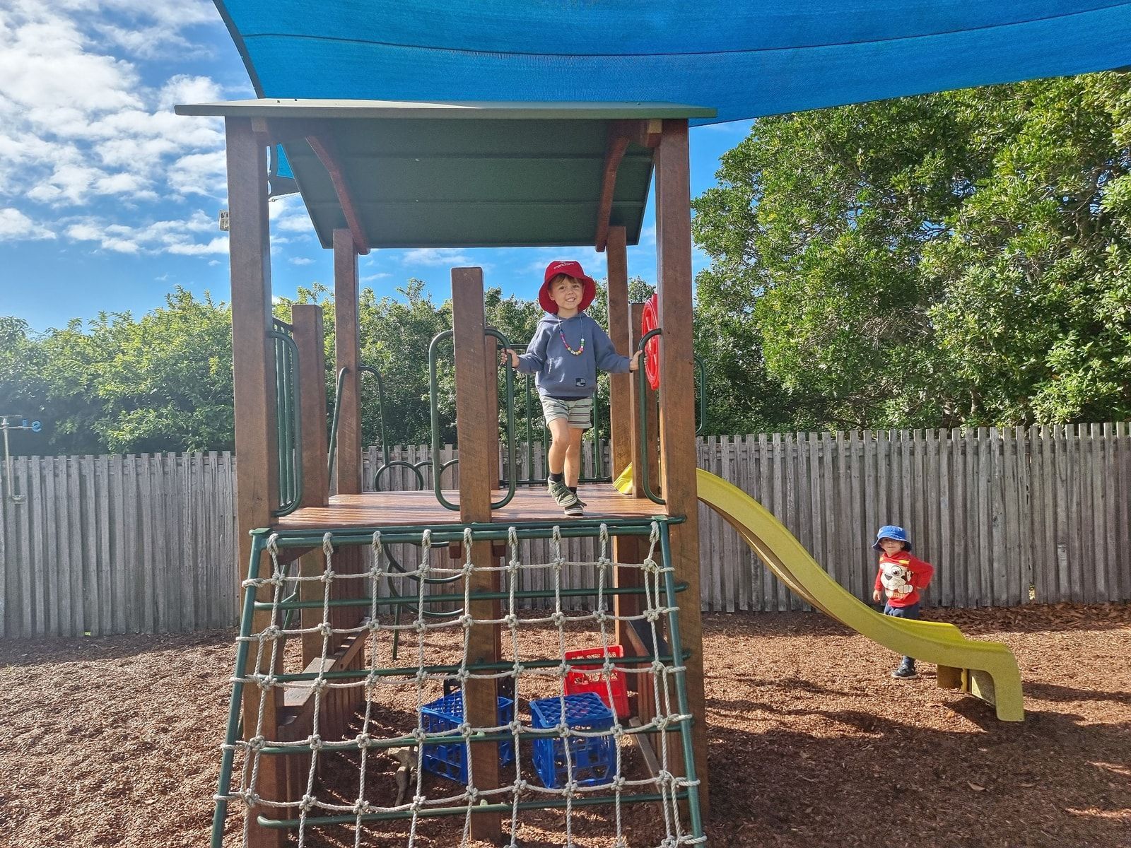 Two Young Children Are Playing With A Stack Of Tires – Bundaberg North, QLD - Cradle to Crayons Education & Care