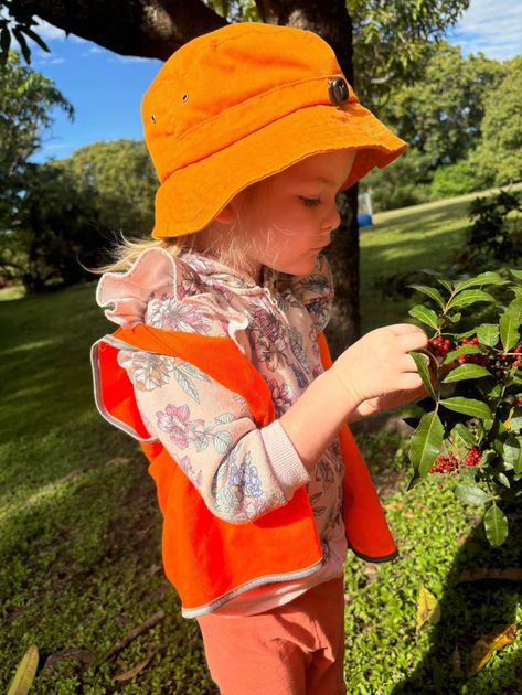 A Young Boy Wearing A Blue Hat Is Climbing A Tree – Bundaberg North, QLD - Cradle to Crayons Education & Care