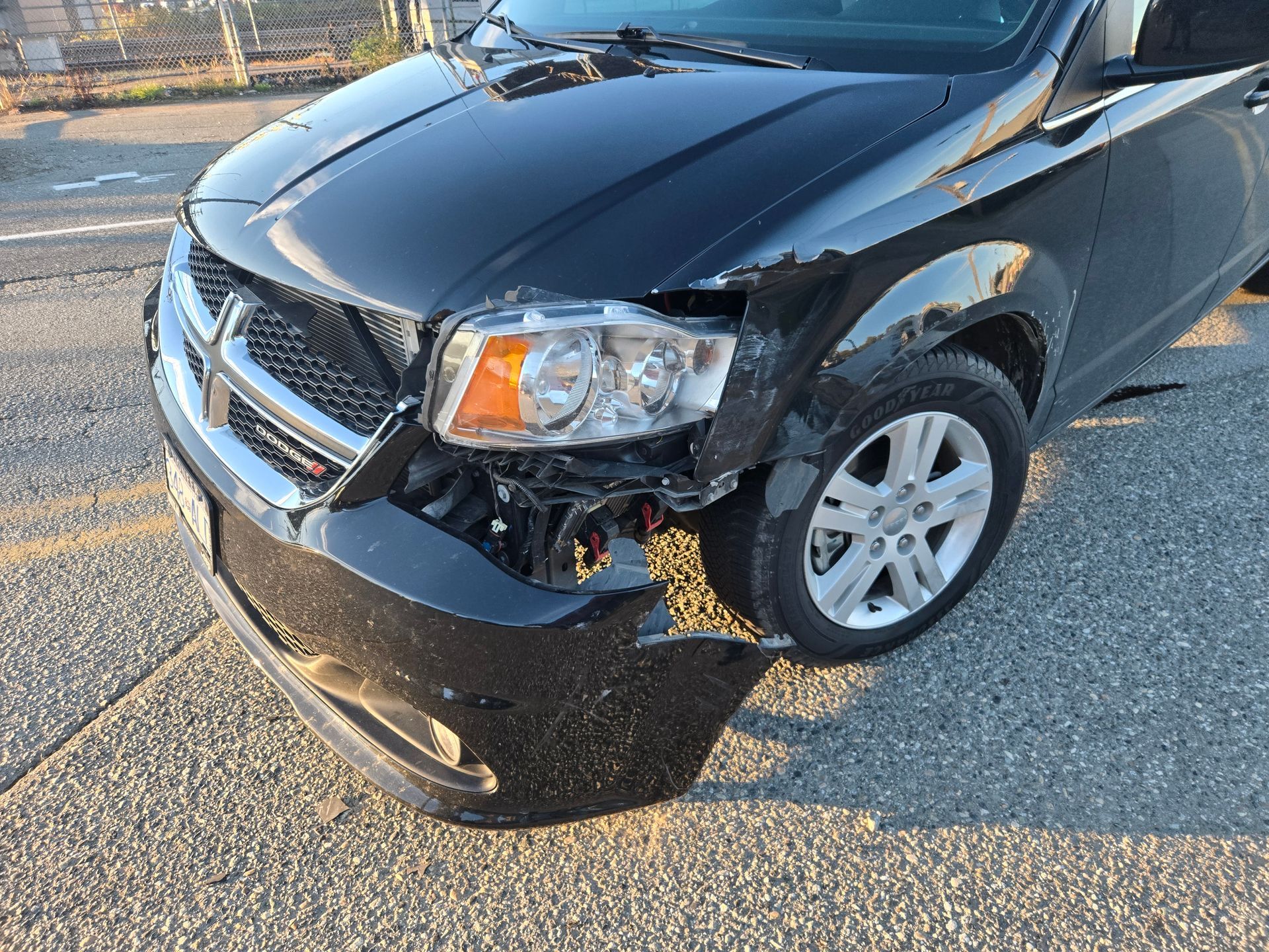 Before: Front-end collision damage on red sedan