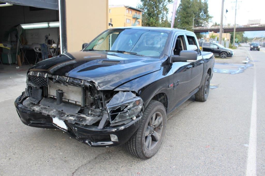 Before: Dented door and quarter panel on grey compact
