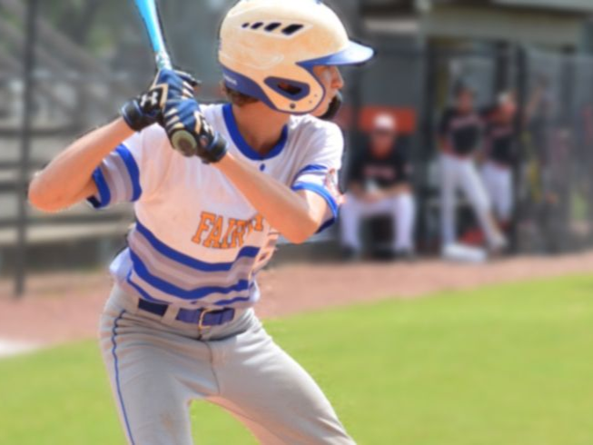 Baseball batter in white and blue uniform preparing to swing at the plate
