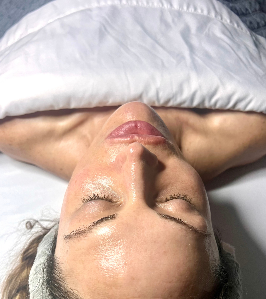 A woman is getting a facial treatment at a beauty salon.