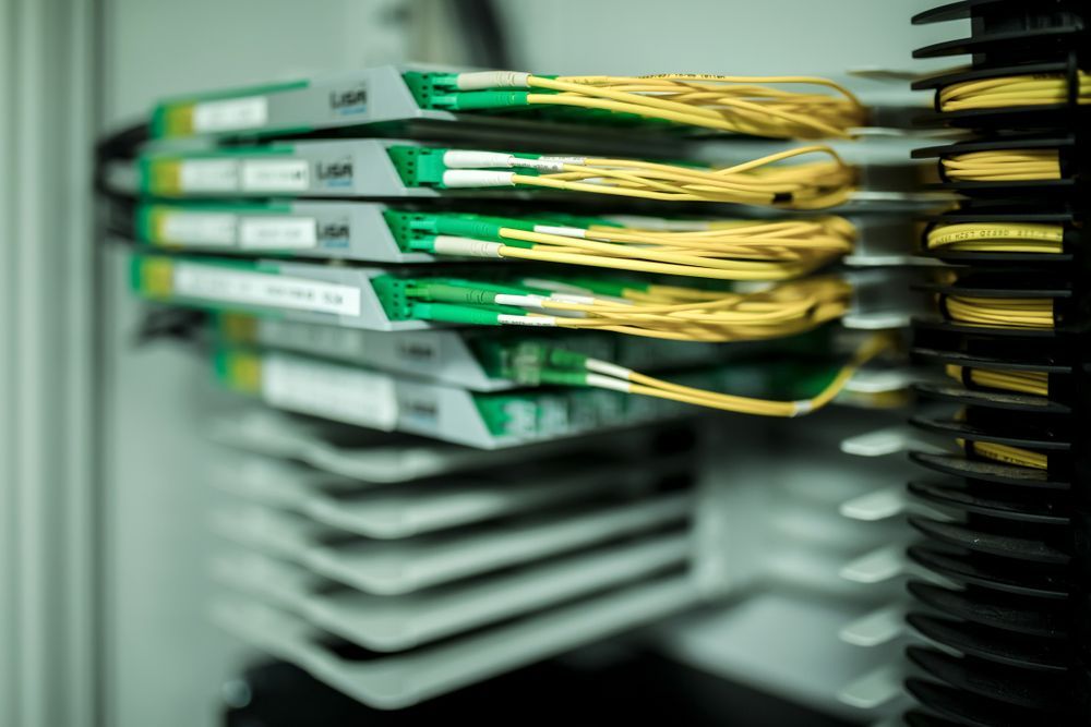 Stacked green and white circuit boards in a computer server rack