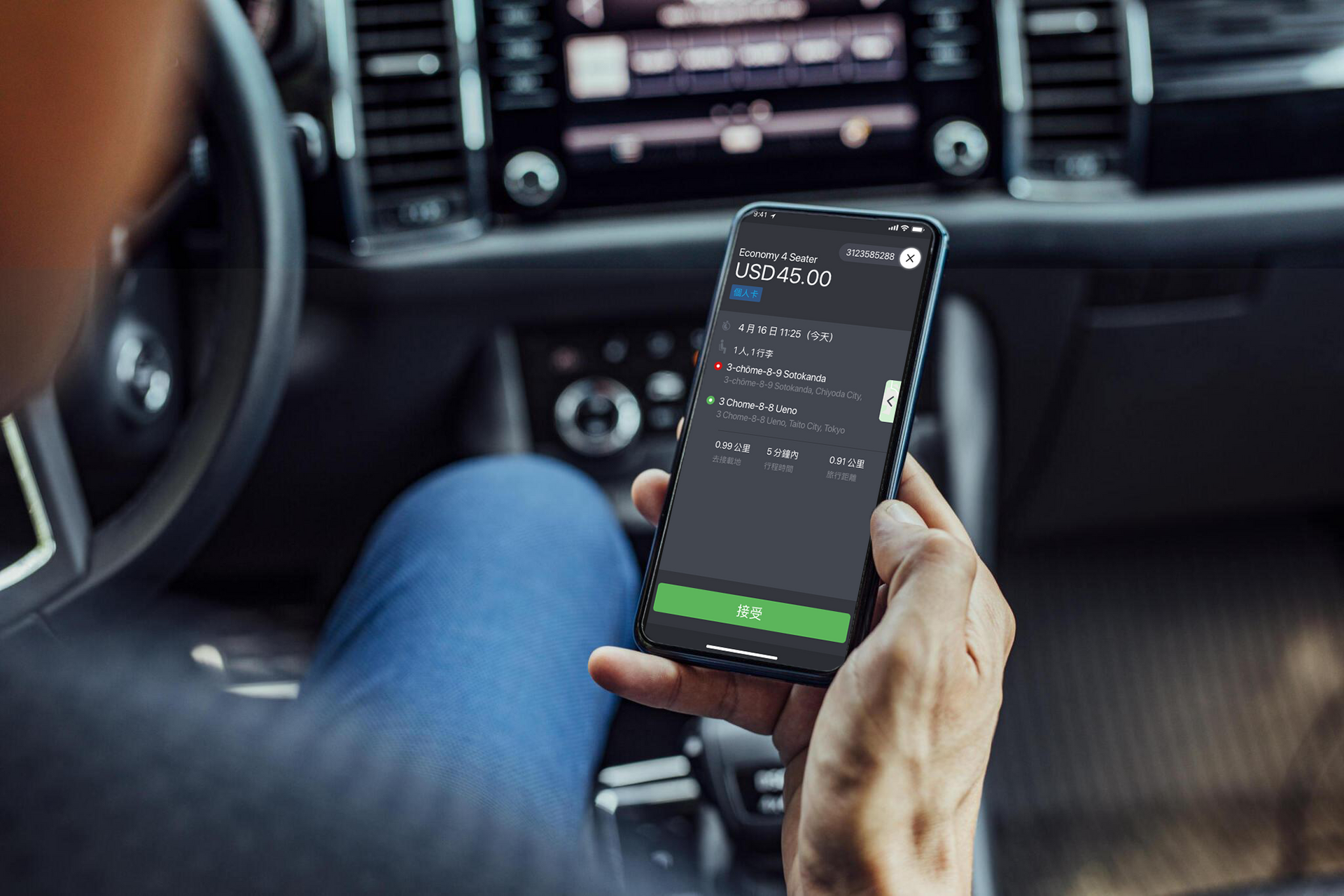 A man is sitting in a car using a cell phone
