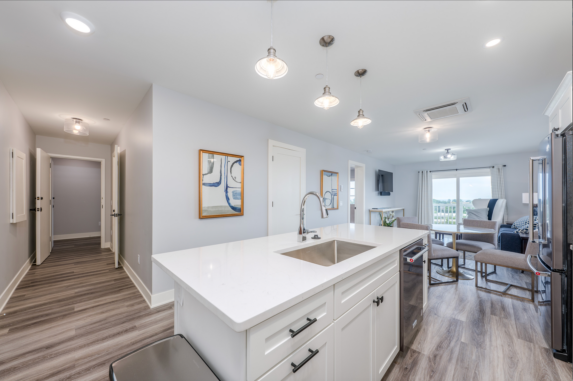 A kitchen with a large island and a sink in a house.