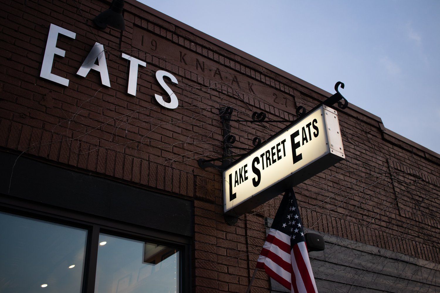 A brick building with a sign that says eats on it