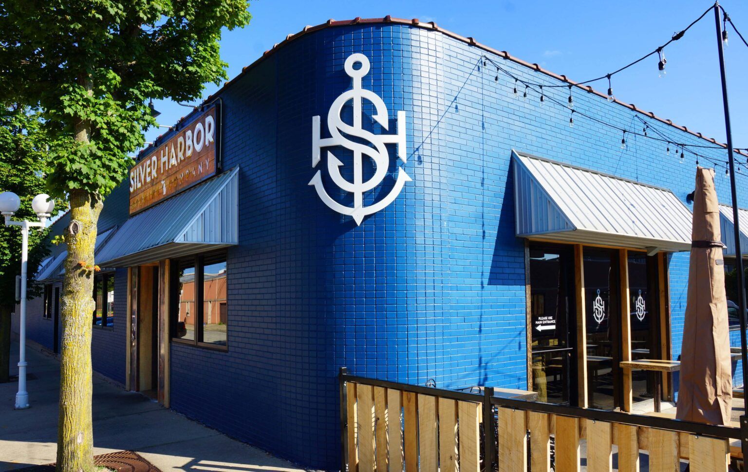 A blue building with an anchor on the side of it.