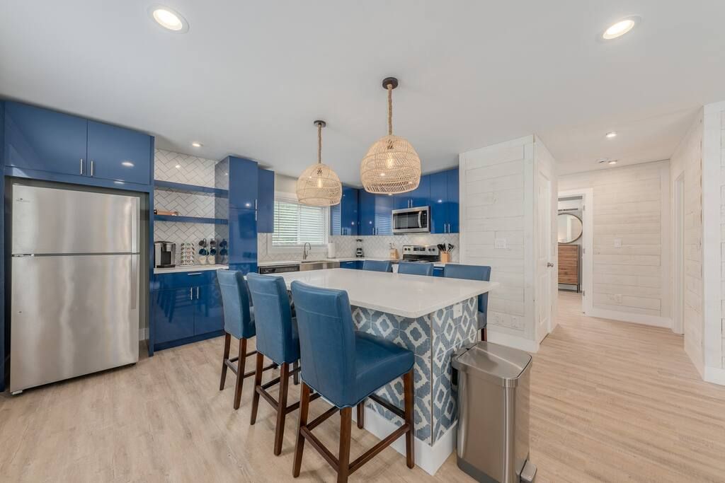 A kitchen with blue cabinets and stainless steel appliances