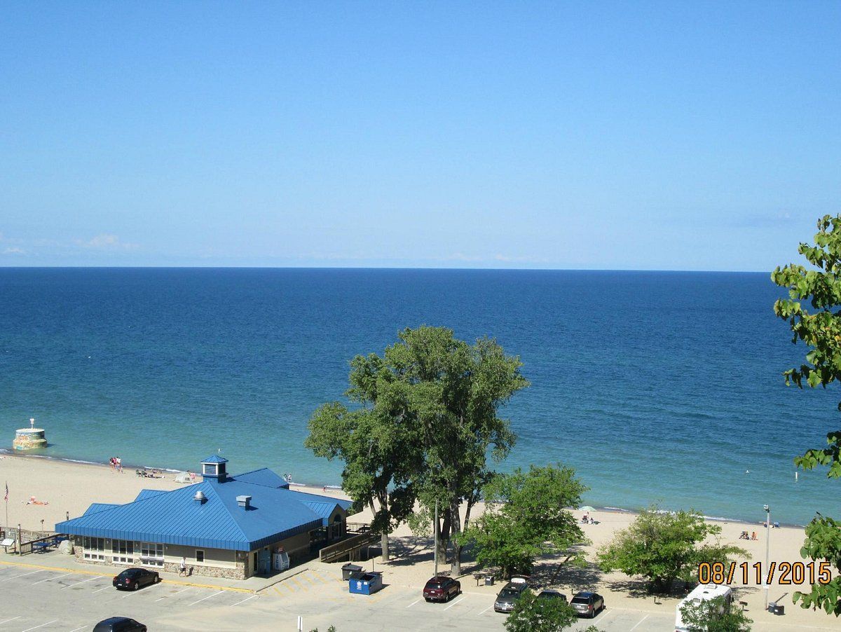 An aerial view of a beach with a blue building in the foreground