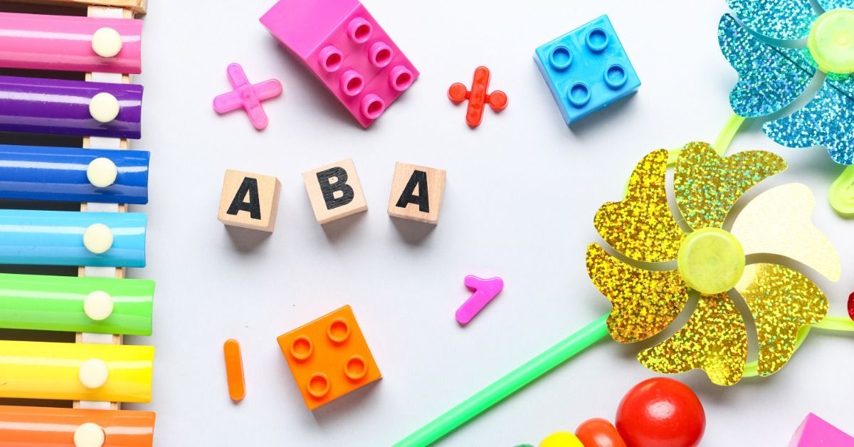 A colorful toy set surrounds wooden letter blocks that spell out