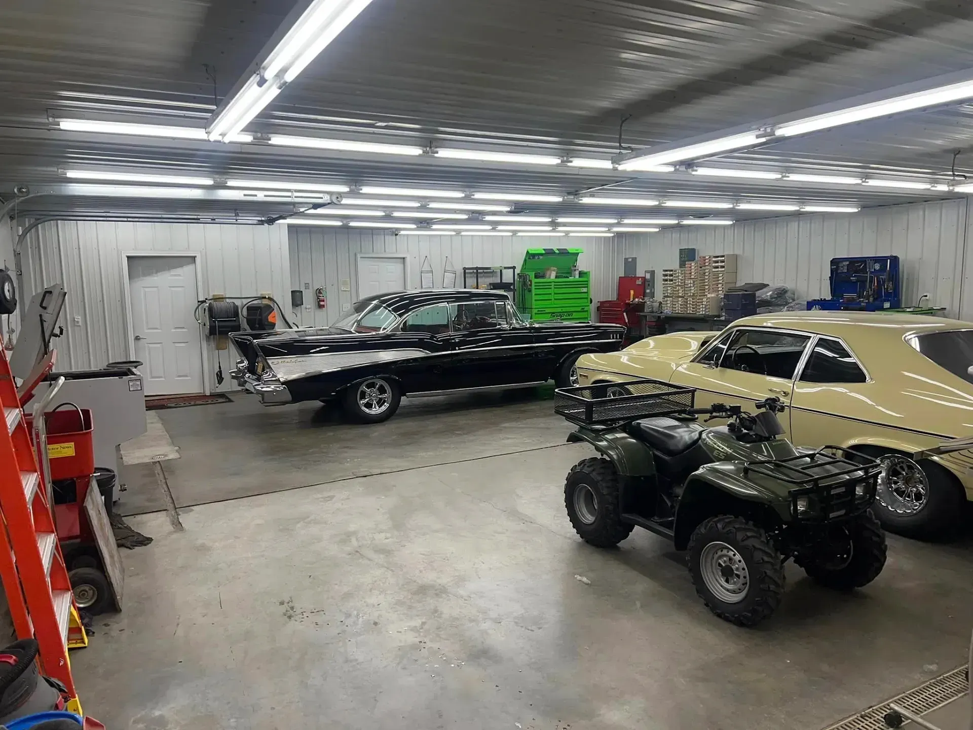 Garage with a Black Classic Car, ATV, and a Yellow Car | Auto Care Center