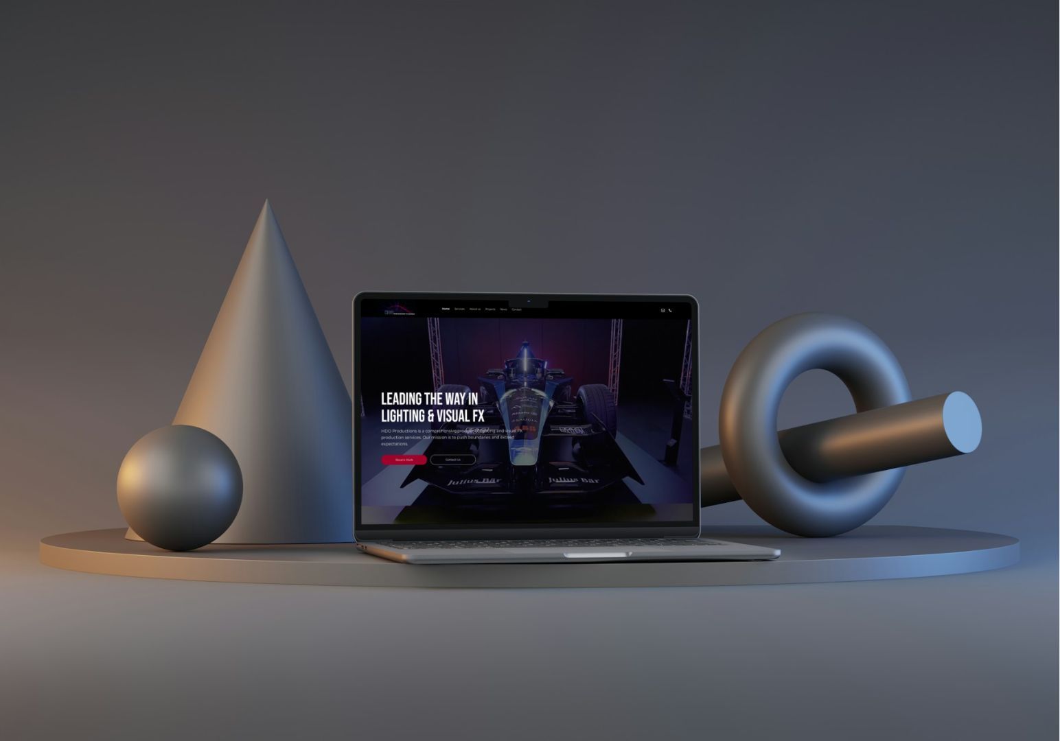A laptop sits on a grey circular platform, flanked by a cone, sphere, and torus, against a minimalist dark grey background.