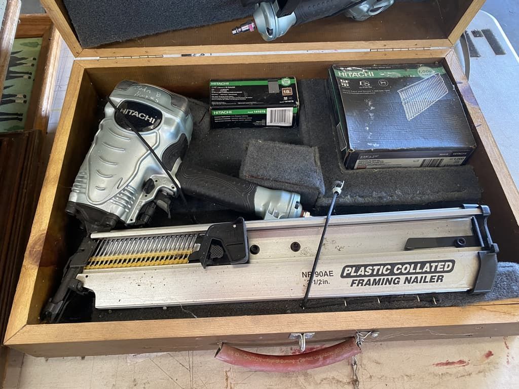 a silver tool in a wood case
