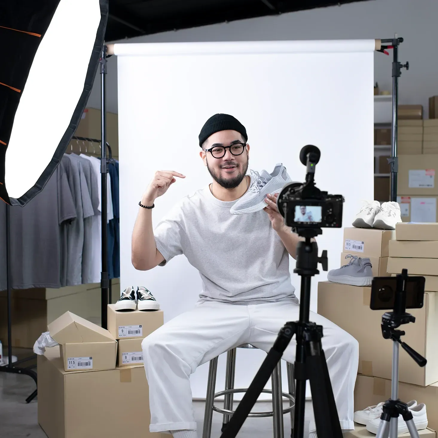 Male YouTubers filming a video in his home studio