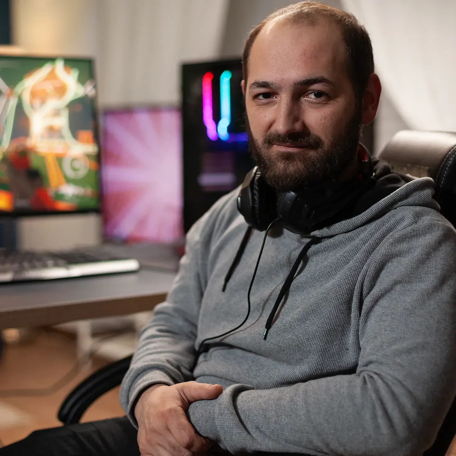 Male streamer sat at his desk in his home gaming studio