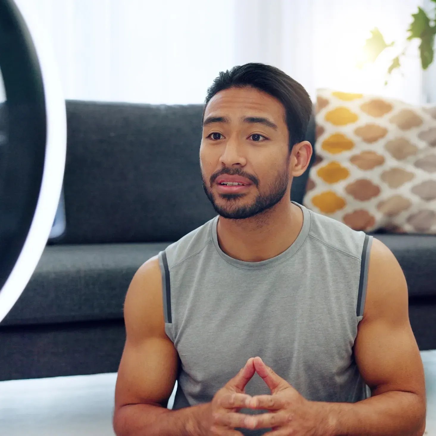 Young, male influencer recording a video at his home