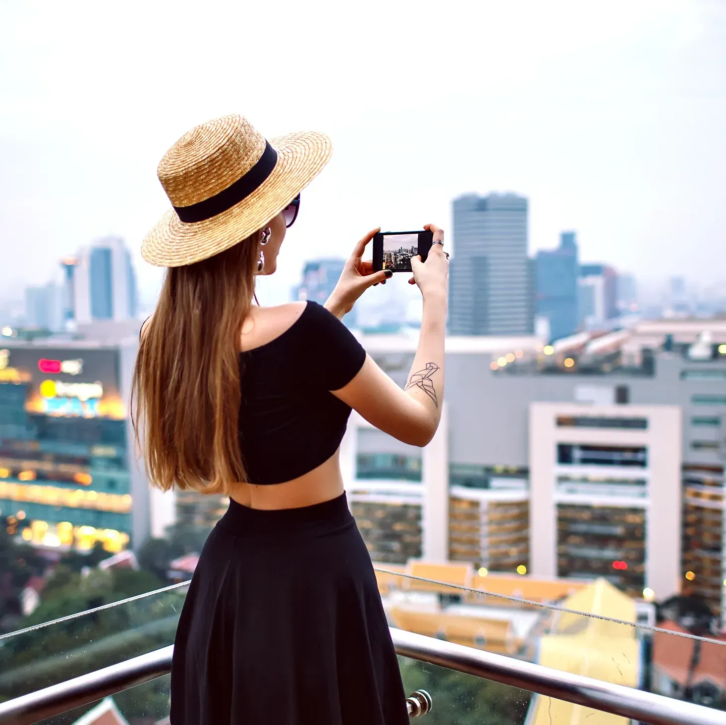 Female travel influencer taking a photo on her phone whilst abroad