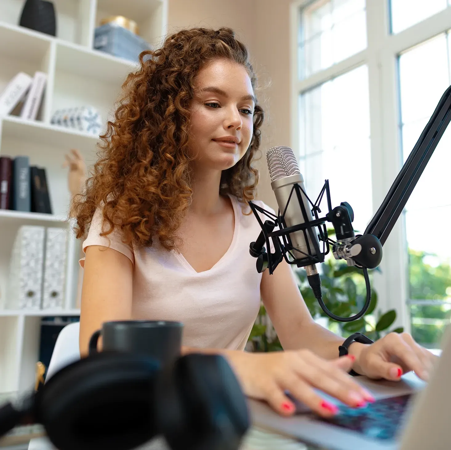 Young, female YouTuber recording a video in her home studio