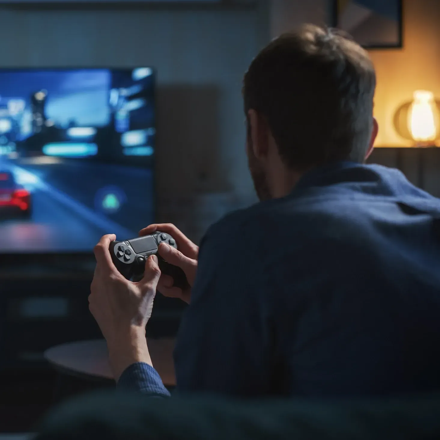 Male playing a video game on a large television