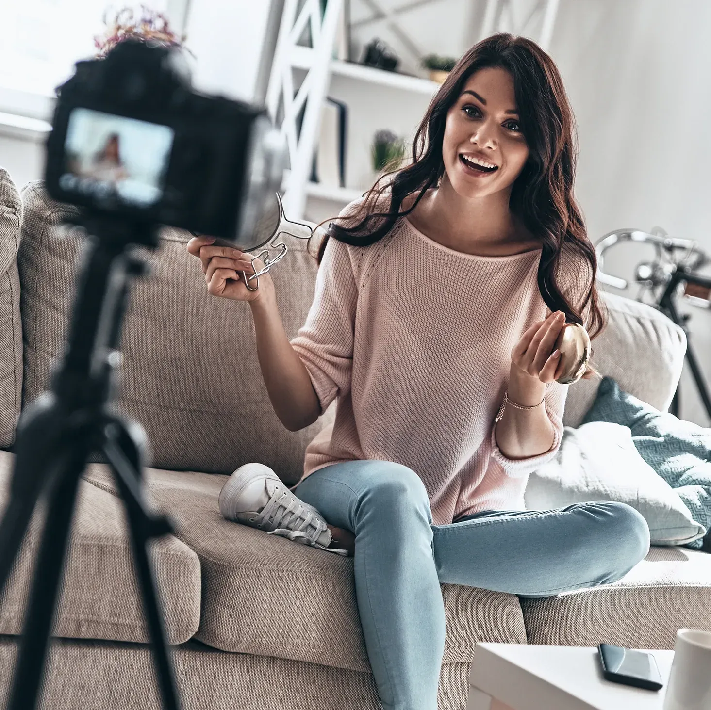 Female YouTuber recording a video in her living room