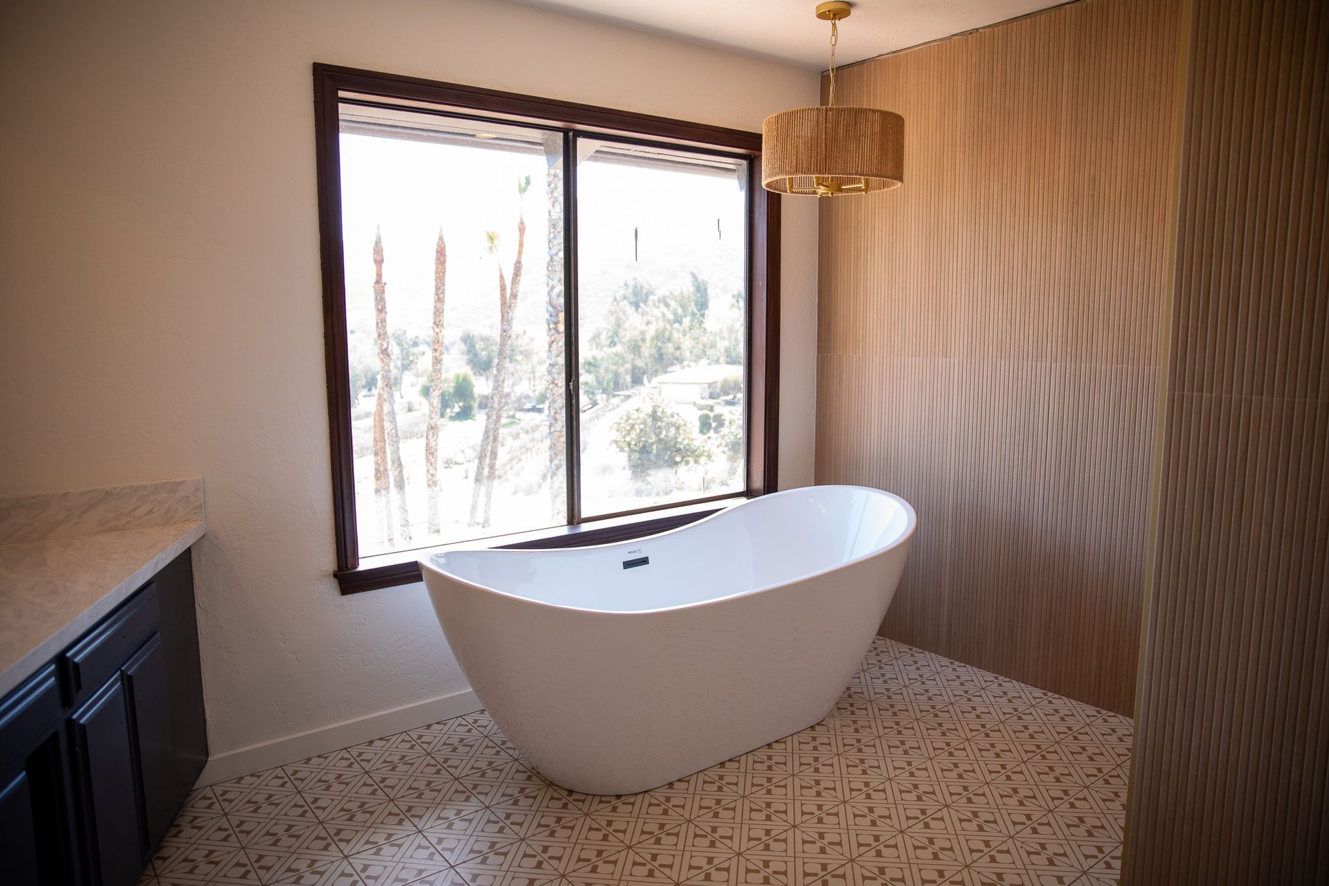 A bathroom with a bathtub and a window.