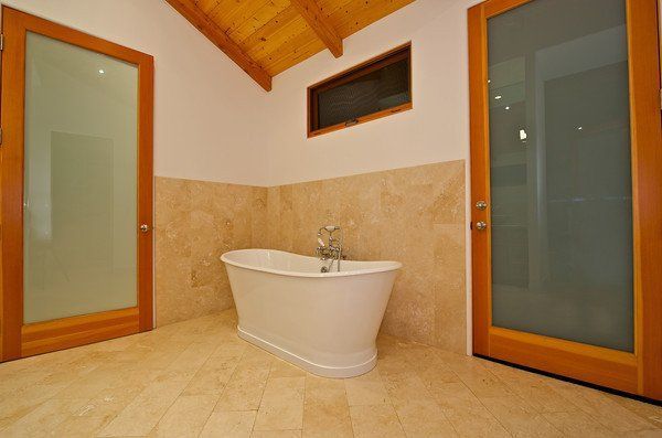 There is a bathtub in the middle of the bathroom.