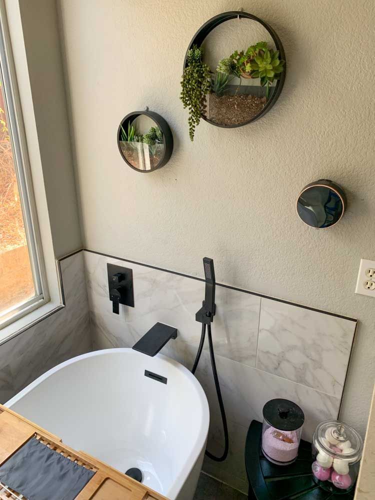 A bathroom with a bathtub and a window.