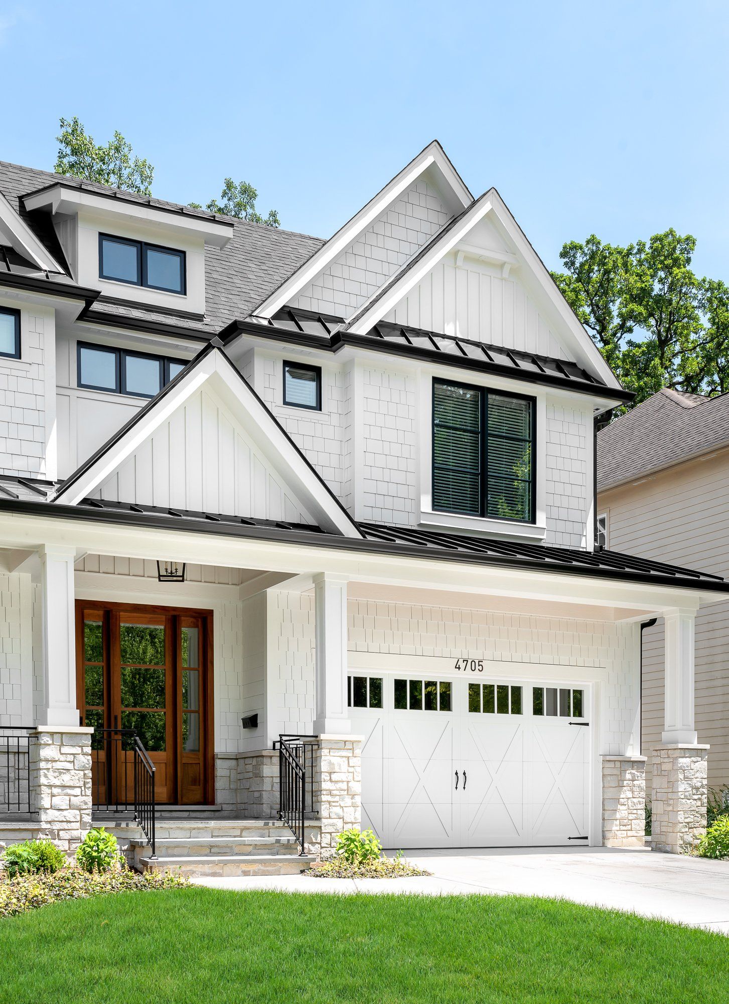 A large white house with a large garage door