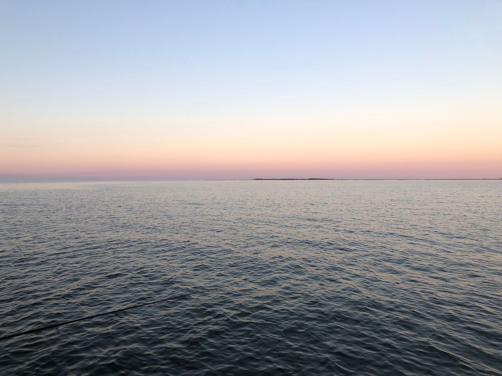 A large body of water with a sunset in the background