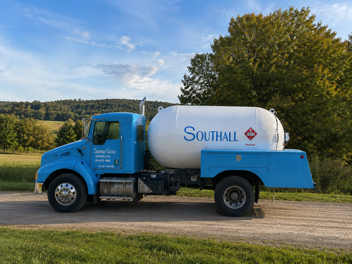 Worker handling orange propane tank in industrial gas storage area.