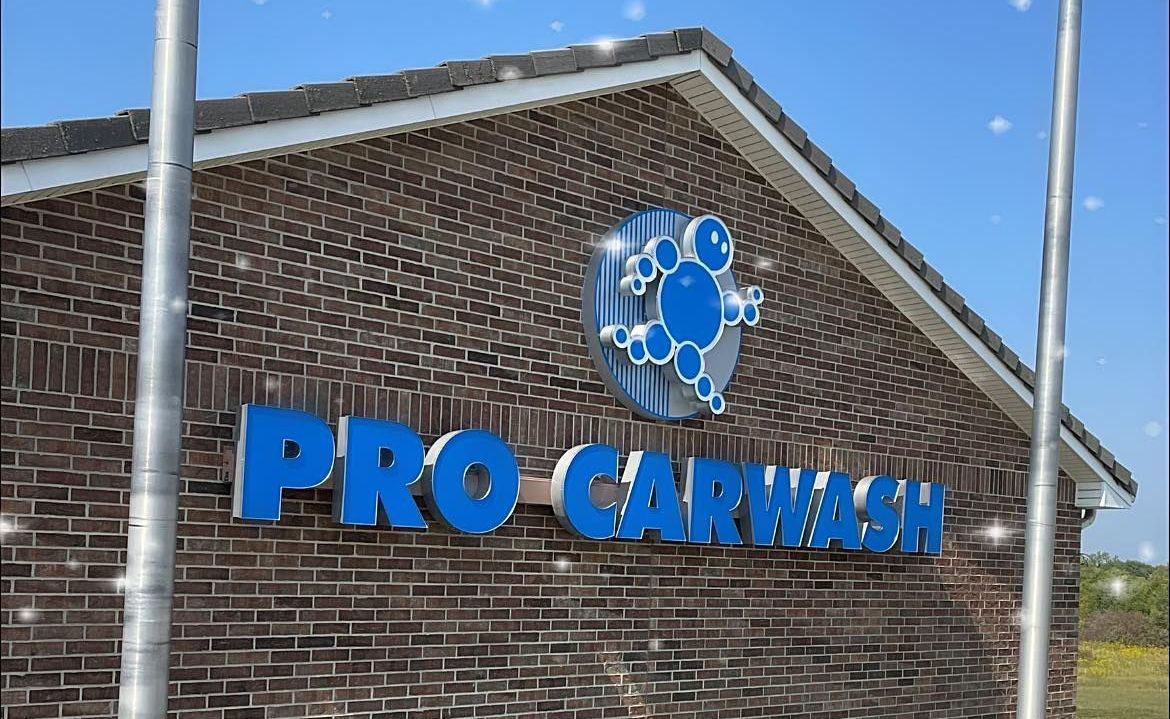 Pro Carwash Bubble Man Logo and Sign on brick facade of a carwash building
