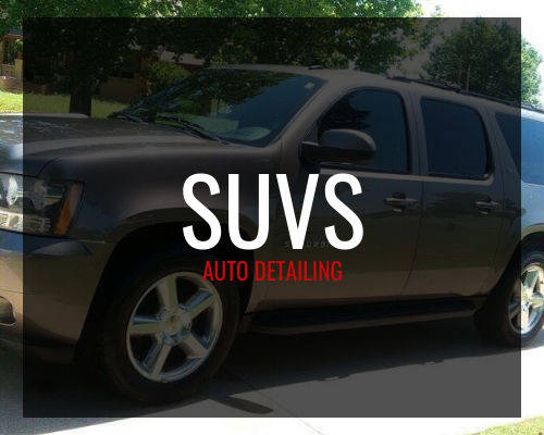 Black SUV with “SUVS Auto Detailing” text overlaid, parked outdoors among trees.