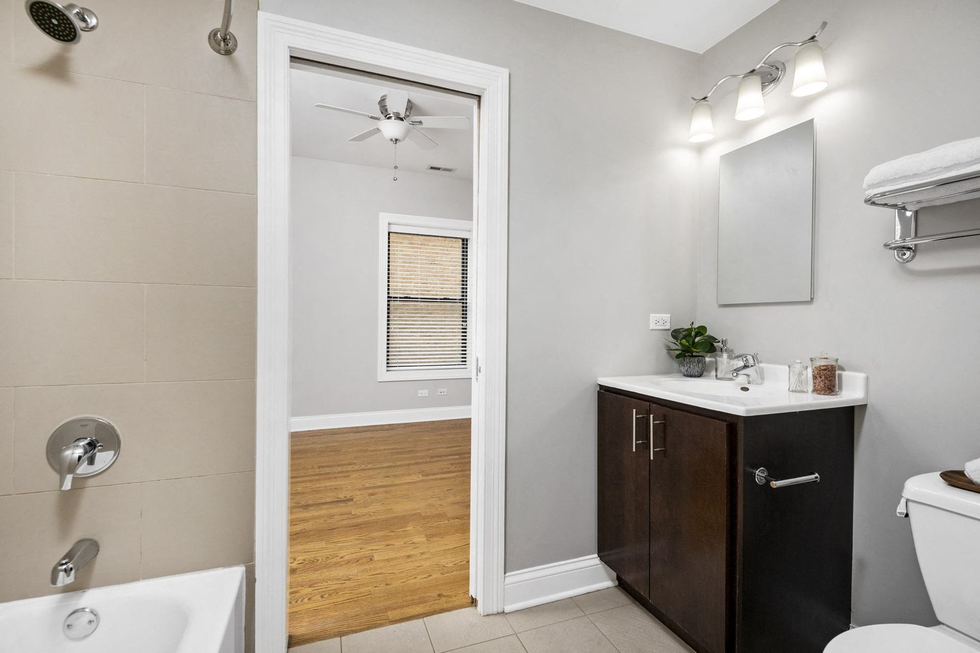 a bathroom with a toilet and a sink and a mirror