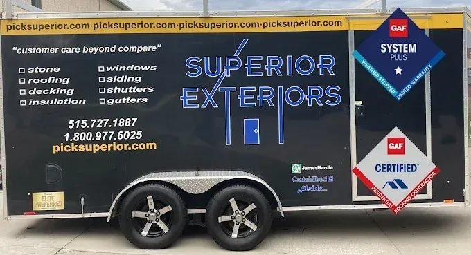 Blue Superior Exteriors trailer with service list, logo, and certification badges parked outdoors