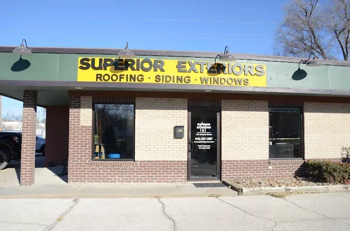 Superior Exteriors storefront with yellow sign for roofing, siding, and windows