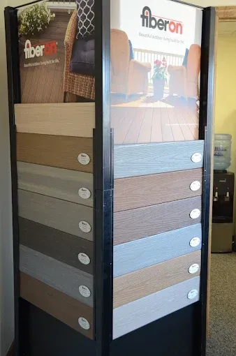 Fabric display stand with multiple wood and paint finish samples in a showroom