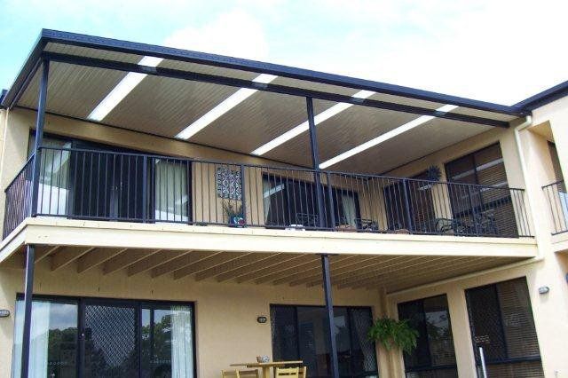 Two-story house exterior with a covered balcony and sliding glass doors