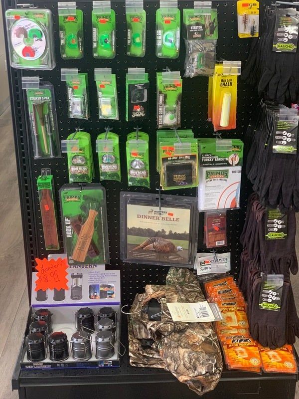 A display case filled with a variety of hunting items