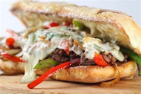 A close up of a sandwich on a wooden cutting board.