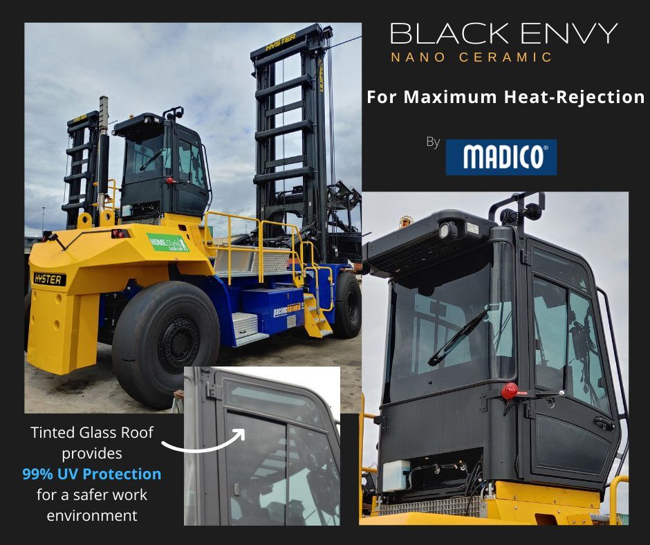 A yellow and blue industrial vehicle with tinted cab windows featuring Madico Black Envy nano-ceramic heat-rejection film.