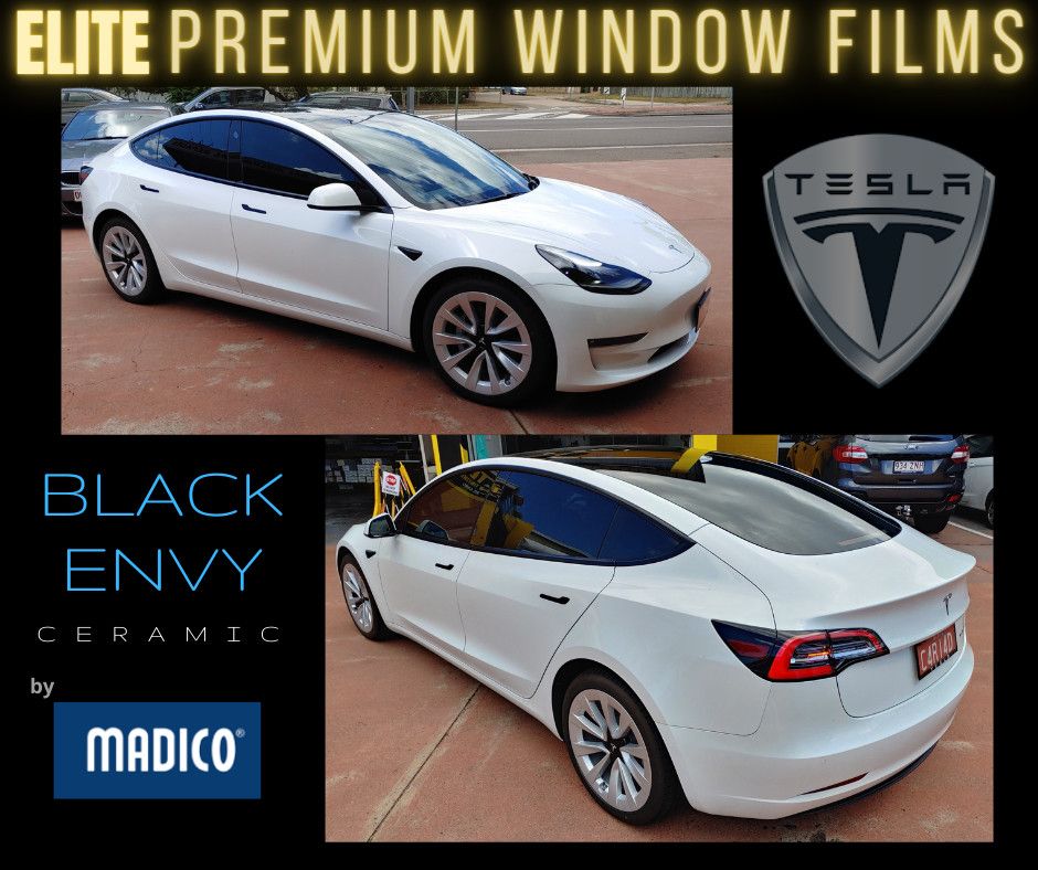 White Tesla with tinted windows, featuring the Madico Black Envy branding and a Tesla logo.