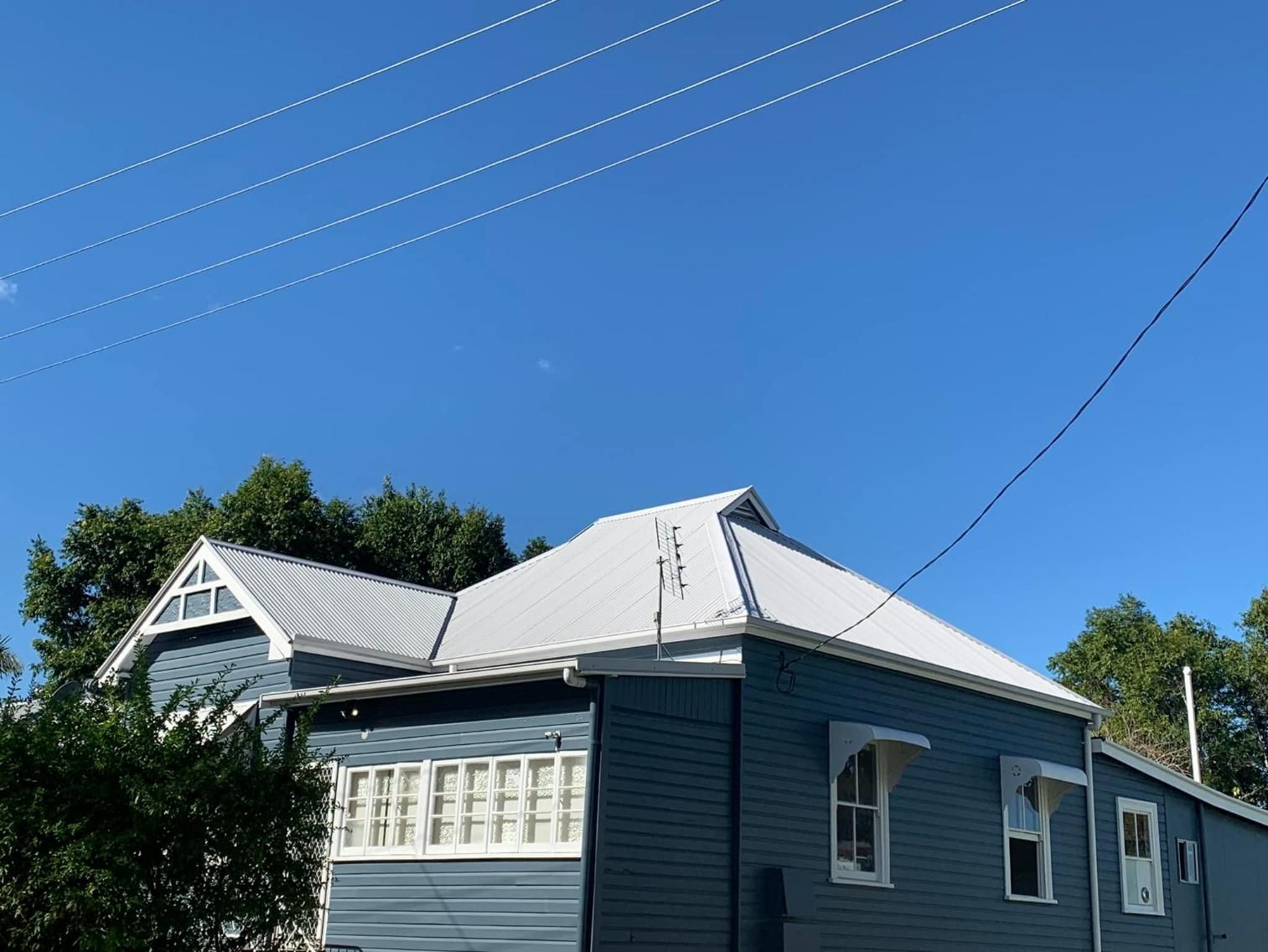 Blue House With White Trim and a Silver Roof — Blue Sky Roofing NSW In Pottsville, NSW