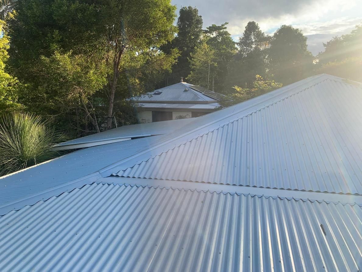Gray Corrugated Metal Roof With Trees — Blue Sky Roofing NSW In Mullumbimby, NSW