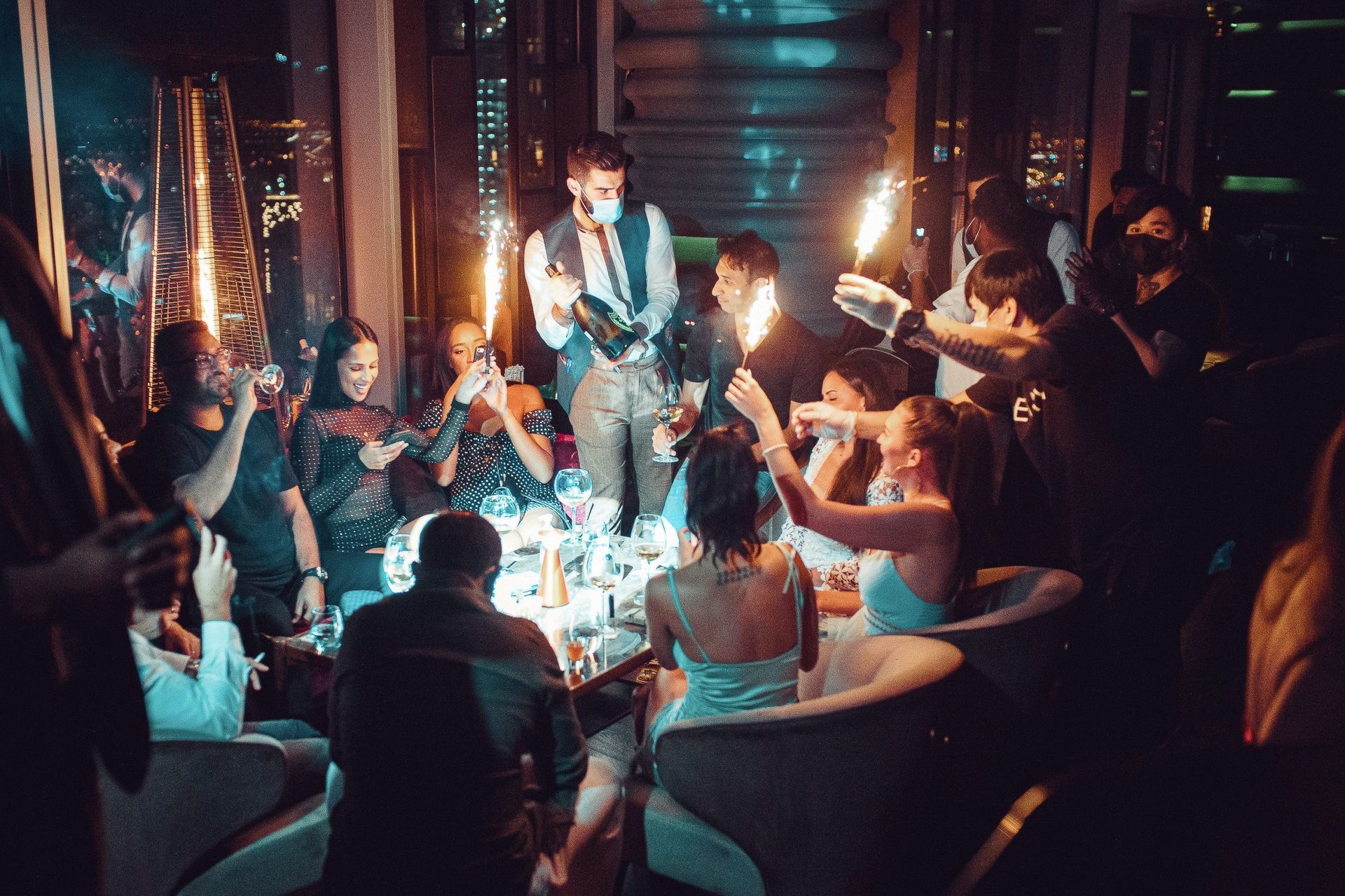 A group of people are sitting around a table at a party.