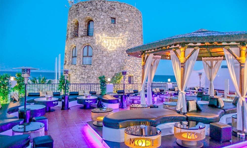 There is a tower in the background and a gazebo in the foreground.