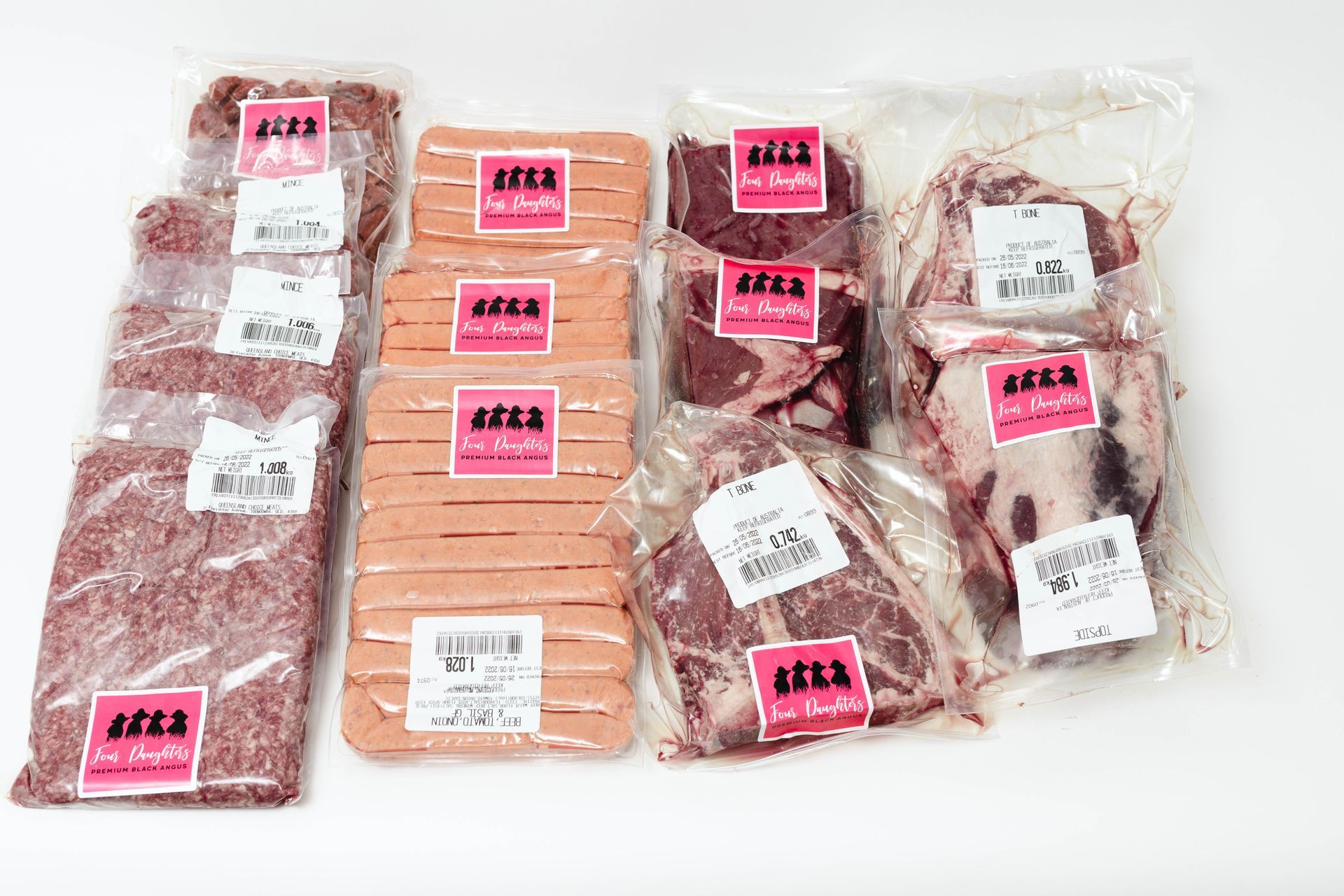 Assorted vacuum-sealed packaged meats on a white background.