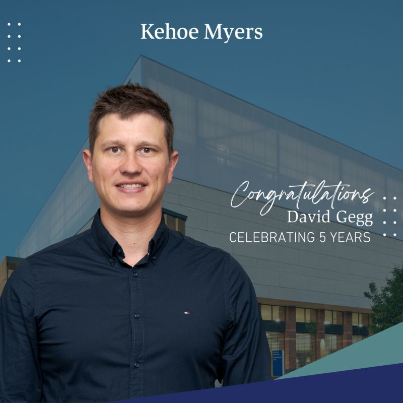 Portrait at Kehoe Myers with a building backdrop, congratulating David Gegg on 5 years