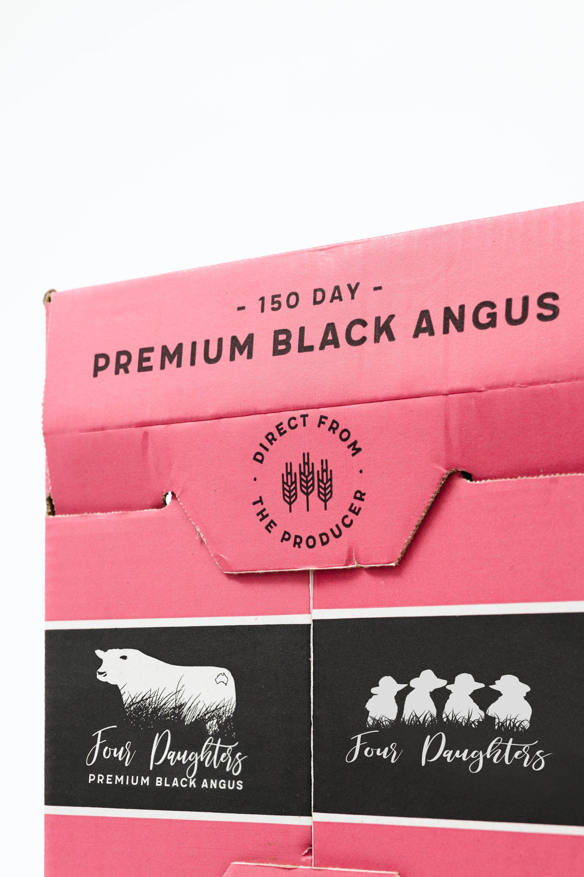 Pink box labeled “150 DAY PREMIUM BLACK ANGUS” with two black panels showing white cow logos and text