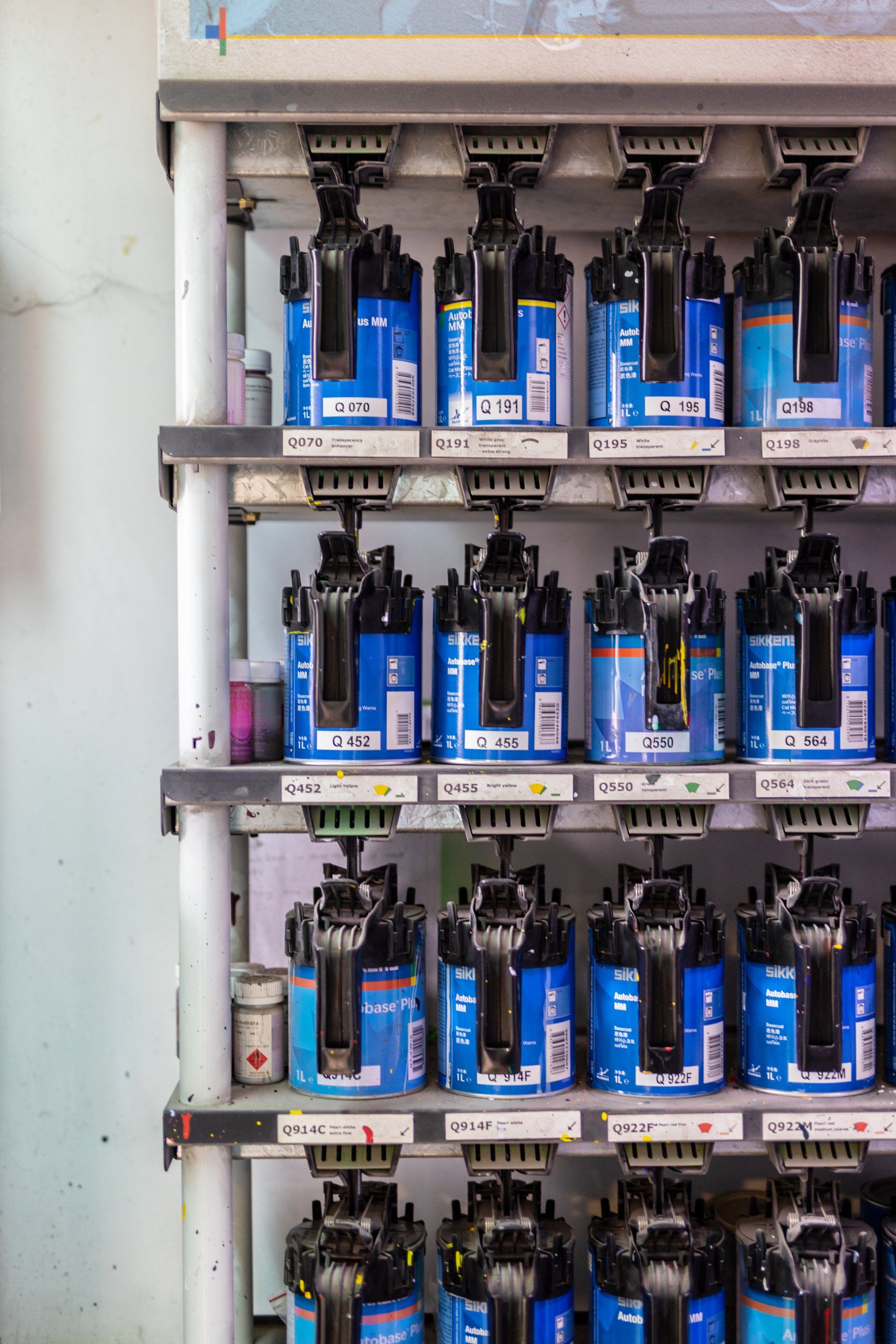 Rows of blue-labeled electrical components mounted inside a cabinet, with black wiring above them
